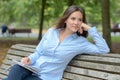 Female writer sitting on park bench Royalty Free Stock Photo