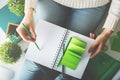 Female writing in spiral notepad closeup