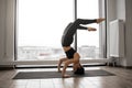 Athletic woman working out yoga in spacious studio