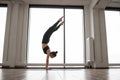 Athletic woman working out yoga in spacious studio