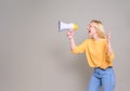 Female young businesswoman screaming over megaphone and making announcement on white background Royalty Free Stock Photo