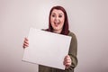 Female young lady holding a blank whiteboard out in front of her