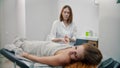 Female young massage therapist massaging hands of her woman client Royalty Free Stock Photo