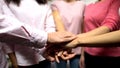 Females with cancer in pink shirts putting hands together, support, feminism Royalty Free Stock Photo