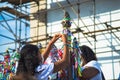 Females decorating a pole with colorful ribbons during the famous Senhor do Bonfim church