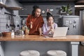 Females discussing recipes while preparing dinner at kitchen Royalty Free Stock Photo