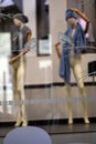 females fashion store, mannequins with hats and scarves, details of shop window, selective focus Royalty Free Stock Photo