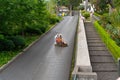 Females getting a ride on a toboggan down the hill in Madeira Portugal