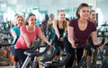 Females riding stationary bicycles Royalty Free Stock Photo