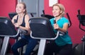 Females riding stationary bicycles in gym Royalty Free Stock Photo