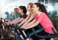 Females riding stationary bicycles Royalty Free Stock Photo