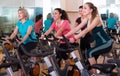 Females riding stationary bicycles Royalty Free Stock Photo