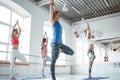 Females traning together yoga poses in white gym Royalty Free Stock Photo