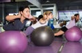 Females working out with aerobic ball in modern gym Royalty Free Stock Photo