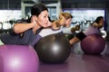 Females working out with aerobic ball in modern gym Royalty Free Stock Photo