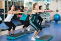 Females working out on aerobic step platform Royalty Free Stock Photo