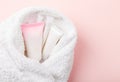 Femine body shaving set covered in towel on pink Royalty Free Stock Photo