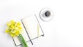 femine workspace long banner. white work desk with coffee mug, notepad, pen and spring flower.