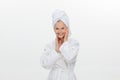 feminine adult older woman wearing bathrobe and towel over her head smiling isolated over white background Royalty Free Stock Photo