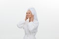 feminine adult older woman wearing bathrobe and towel over her head smiling isolated over white background Royalty Free Stock Photo