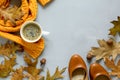 Feminine autumn accessories. Scarf and shoes, cup of coffee, oak leaves and acorns on gray wooden background. Flat lay. Royalty Free Stock Photo