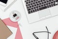 Feminine business desk from above on white background