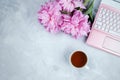 Feminine business mockup with pink laptop, peonies bouquet and cup of warm tea
