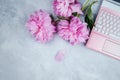 Feminine business mockup with pink laptop and peonies bouquet