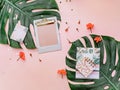 Feminine creative design workspace. Notebook, tropical leaves