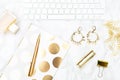 A feminine desk with gold objects. Flat lay