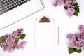 Top view of female worker desktop with laptop, flowers and different office supplies items. Feminine creative design workspace. Royalty Free Stock Photo