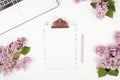 Top view of female worker desktop with laptop, flowers and different office supplies items. Feminine creative design workspace. Royalty Free Stock Photo