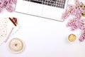 Top view of female worker desktop with laptop, flowers and different office supplies items. Feminine creative design workspace. Royalty Free Stock Photo