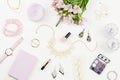 Feminine flat lay with woman fashion accessories, jewelry, cosmetics, coffee and flowers. Top view Royalty Free Stock Photo