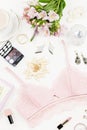 Feminine flat lay with woman fashion accessories, lingerie, jewelry, cosmetics, coffee and flowers. Top view Royalty Free Stock Photo