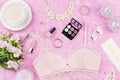 Feminine flat lay with woman fashion accessories, lingerie, jewelry, cosmetics, coffee and flowers. Top view Royalty Free Stock Photo