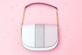 Feminine handbag pastels color on pink background and pearl decoration. Flat lay