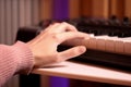 Feminine hands gracefully playing on a MIDI keyboard, showcasing creativity and passion for music in a vibrant setting Royalty Free Stock Photo