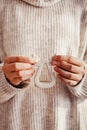 Feminine hands holding a deer shaped candlestick close-up.