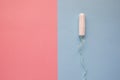 Feminine hygiene tampon on a pink background. The concept of feminine hygiene during menstruation.