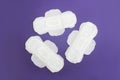 Feminine hygienic white pads for menstruation on a purple background very peri