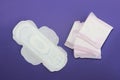 Feminine hygienic white pads for menstruation on a purple background very peri