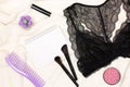 Feminine lifestyle, shopping list concept. Black lace lingerie, perfume, lipstick, comb, make-up blush, makeup brushes, open blank