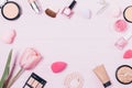 Feminine makeup products on pink table Royalty Free Stock Photo