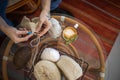 Feminine male hands crochet handmade artwork hobby wooden table with sewing tools closeup top view Royalty Free Stock Photo