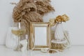 Feminine Mockup vintage gold frame with fluffy branches of dried flowers Royalty Free Stock Photo