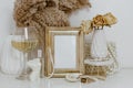 Feminine Mockup vintage gold frame with fluffy branches of dried flowers Royalty Free Stock Photo