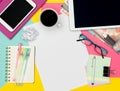 Feminine Office Desk Working Space Flat Lay. Top view photo of workspace with blank sheet of paper mock up and fashion magazines. Royalty Free Stock Photo