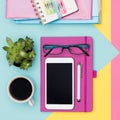 Office Desk Working Space Flat Lay. Top view photo of workspace with smartphone, coffee, notepad and woman fashion magazines.