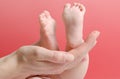 Feminine palm holding a baby foot Royalty Free Stock Photo